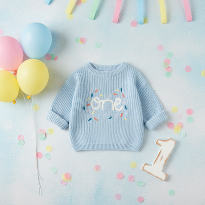 Light Blue Knitted One Jersey styled with pastel balloons, confetti and wooden number 1