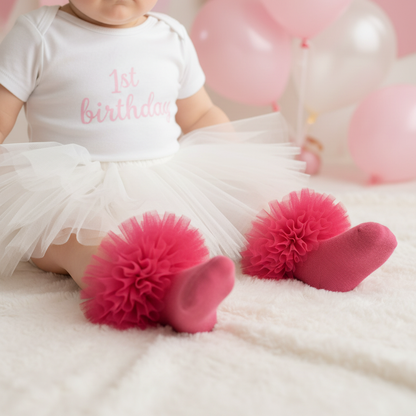 Cerise pink frilly tutu socks paired with white tutu skirt and 1st birthday bodysuit close up